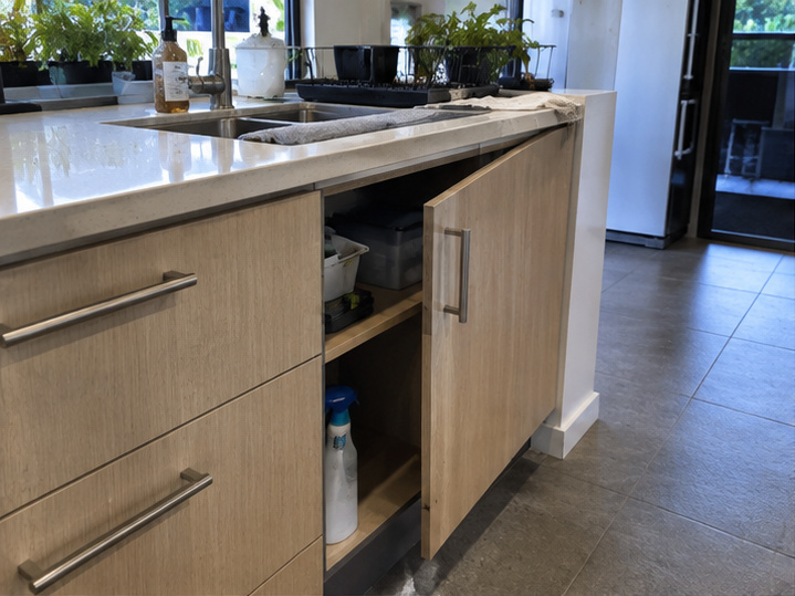 Open kitchen cabinet door before hinge repair