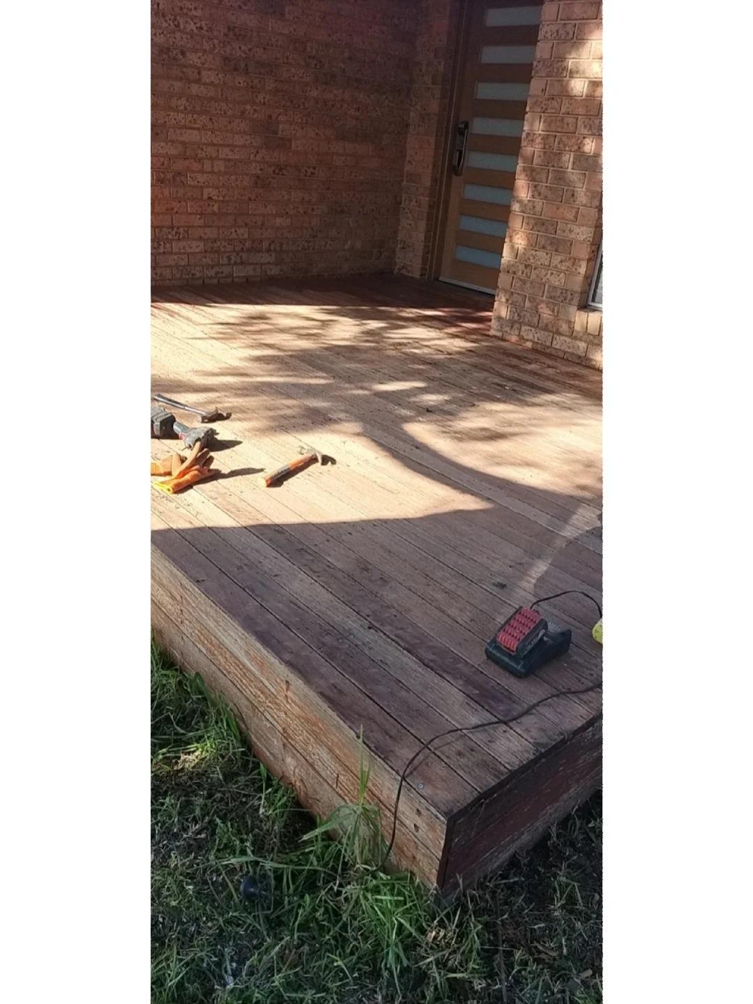 Timber deck surface prepared for refinishing with tools on site