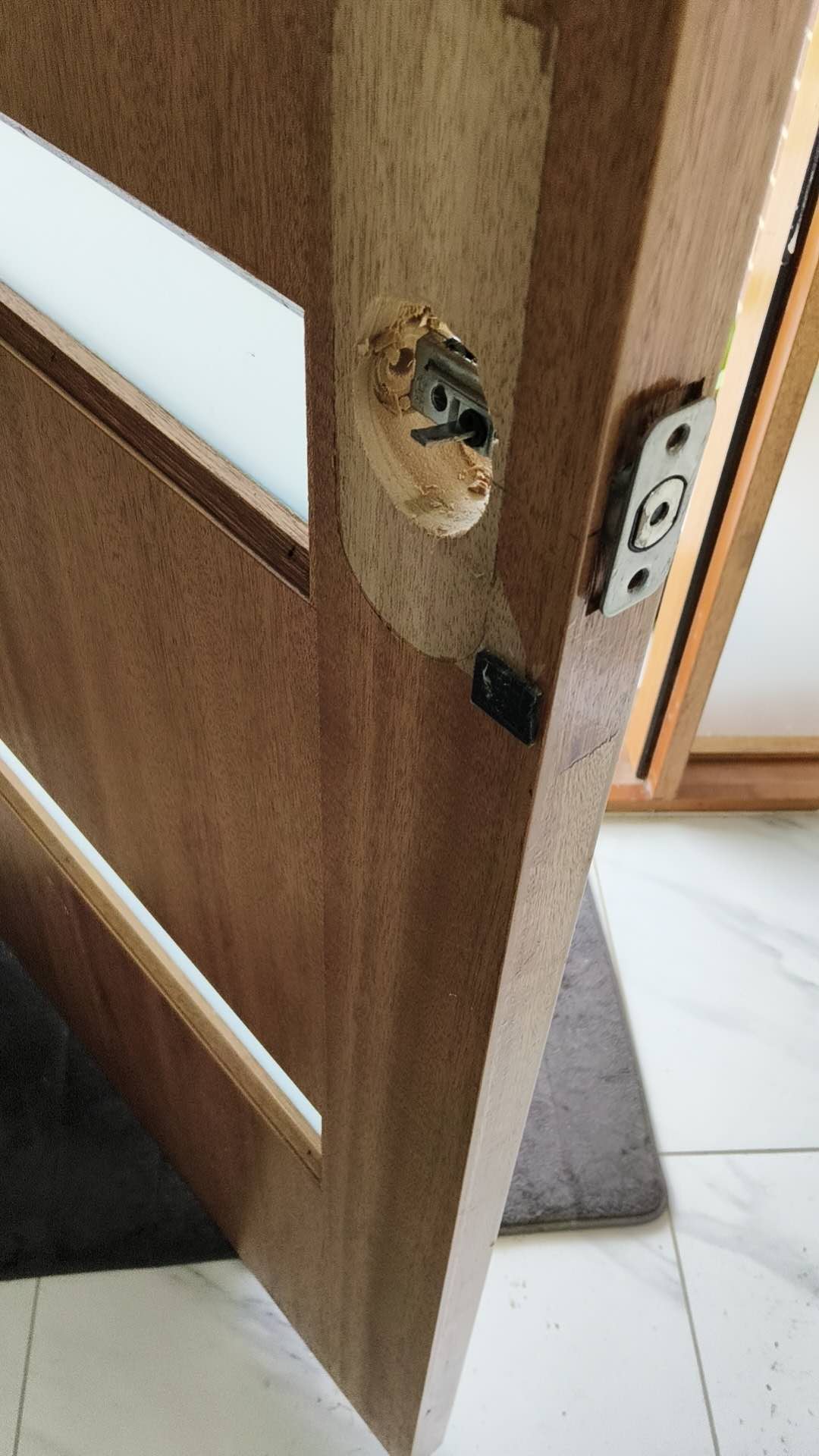 Door edge with existing lock hardware removed